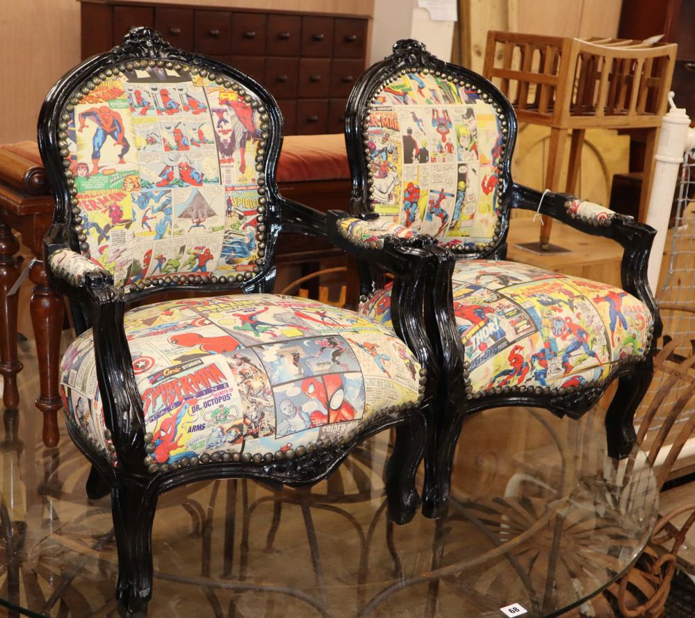 A pair of ebonised childs armchairs, with spiderman upholstery, W.50cm H.70cm